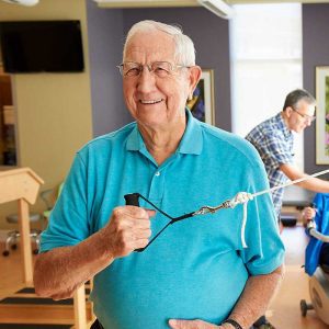 Senior resident getting rehab with caregiver at Rolling Green Village's rehabilitation center