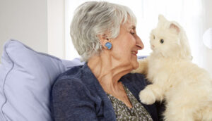 Senior woman with robotic pet