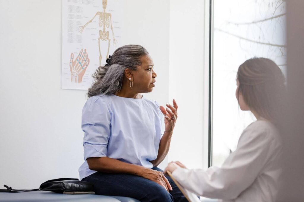 Senior woman talking with her doctor. 