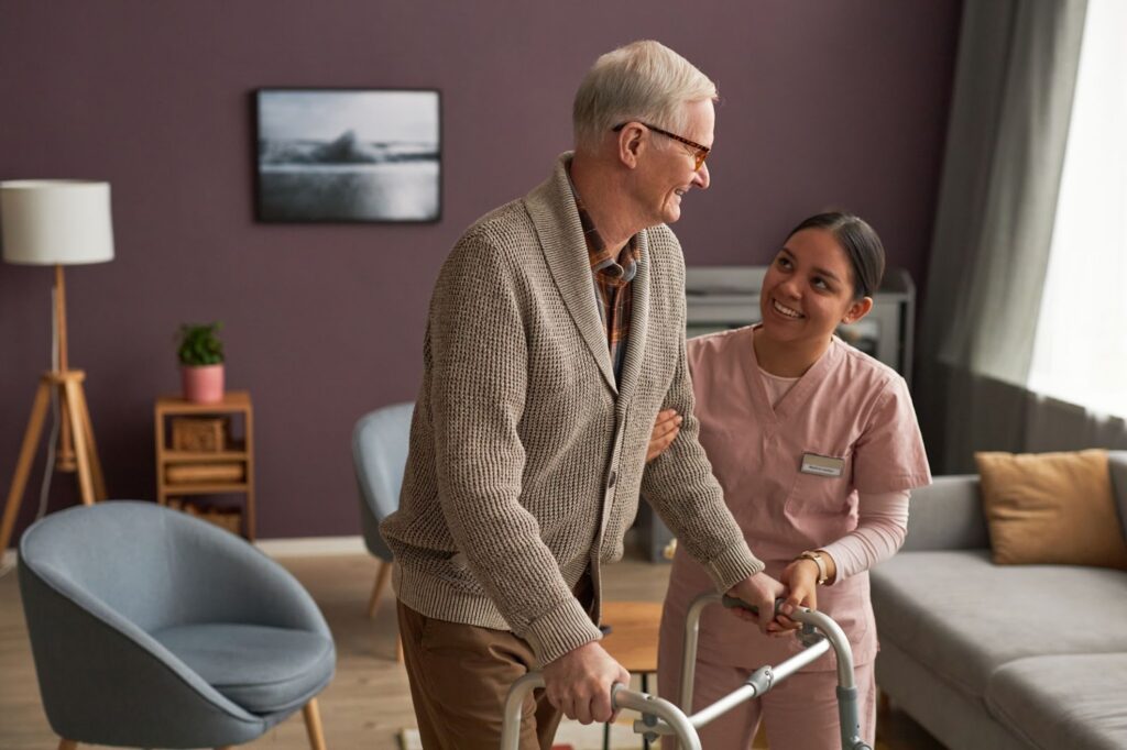 Skilled Nursing nurse helps resident using a walker.