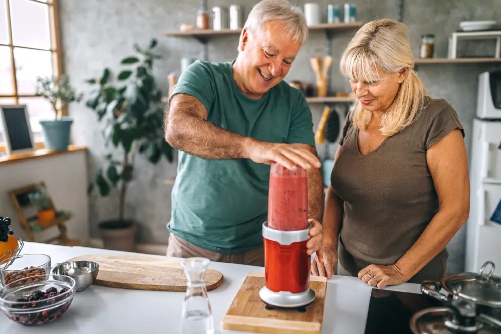 a senior couple blending a healthy smoothie