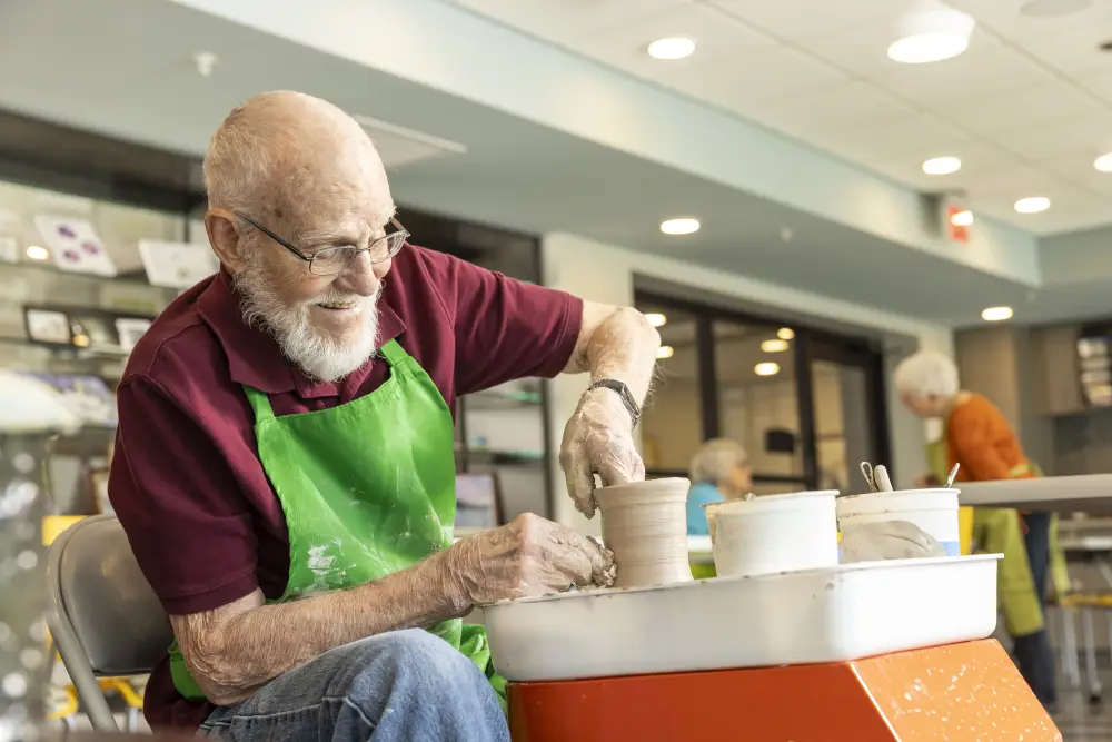 a senior man making pottery at Rolling Green Village